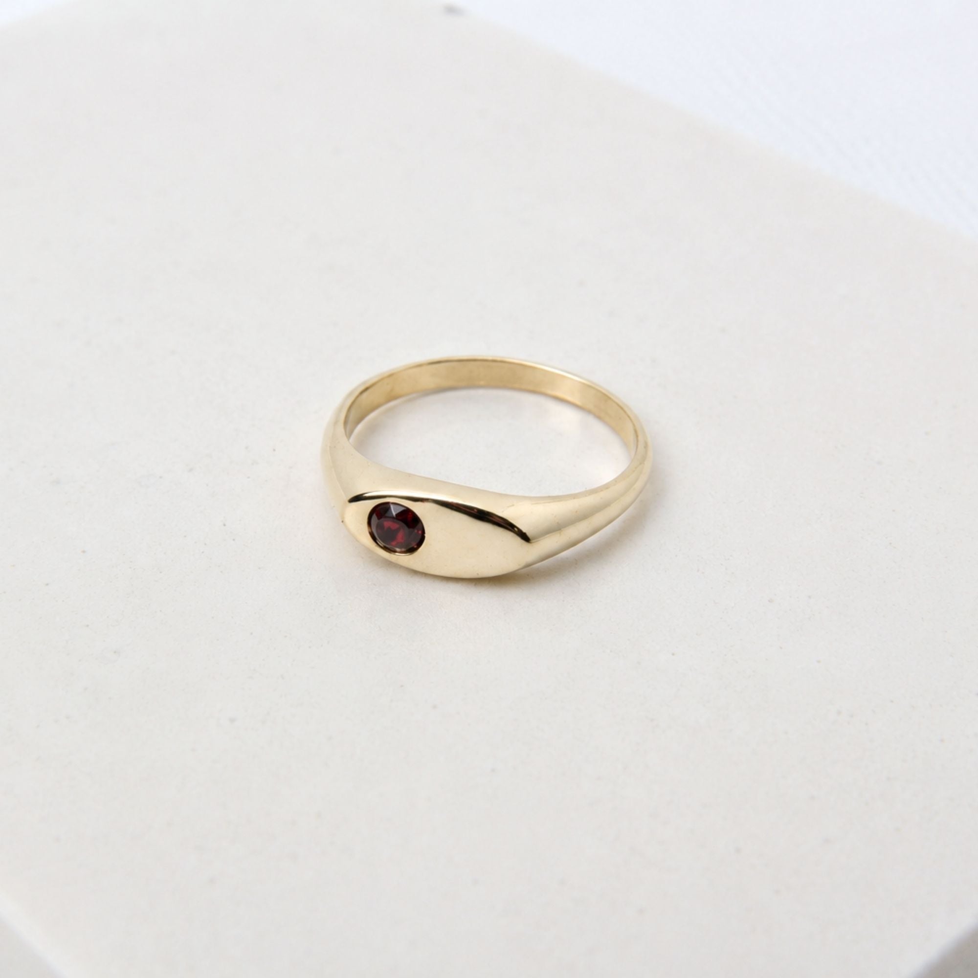 Hand-cast brass signet ring with a garnet gemstone, small-batch jewellery Cape Town — RHYN