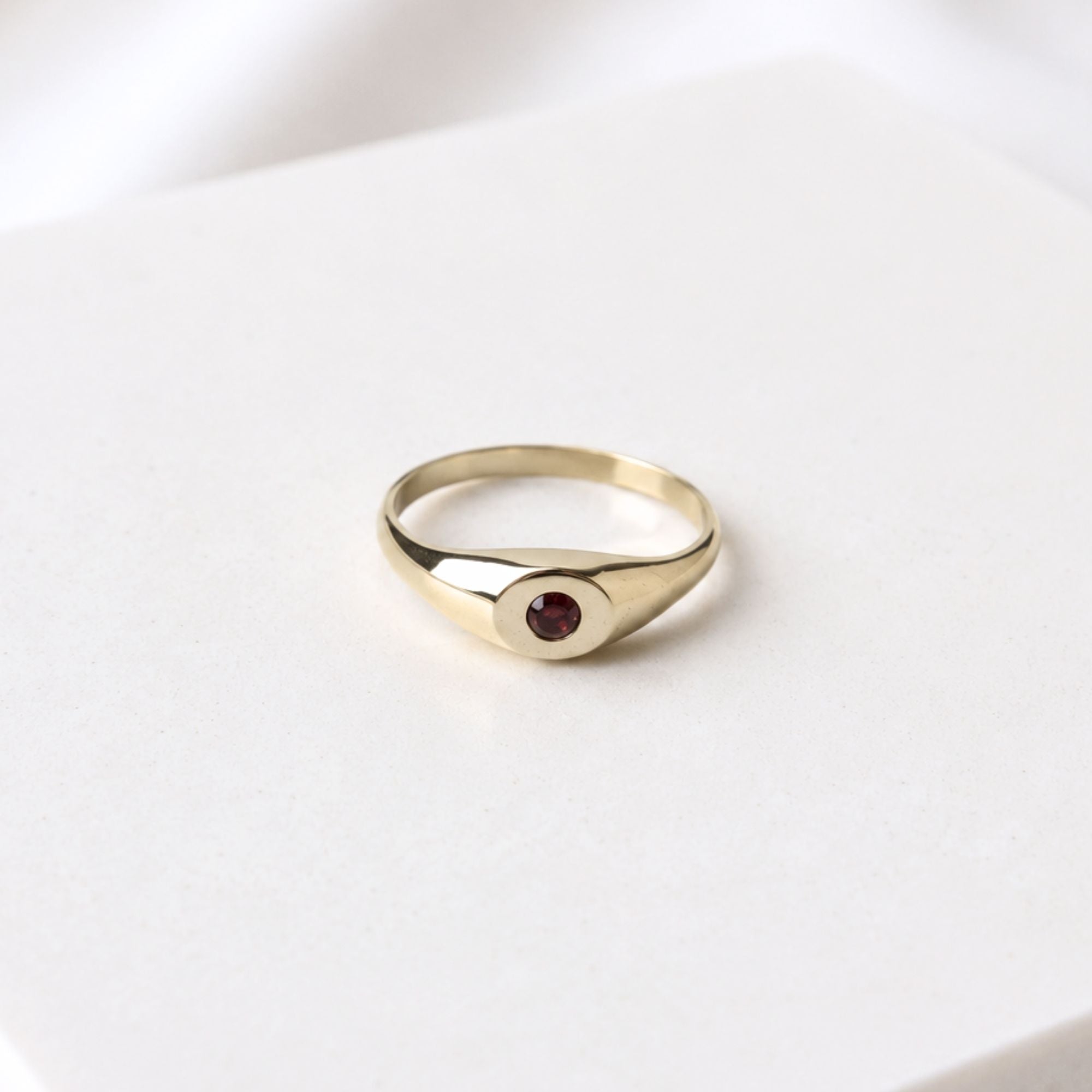 Hand-cast brass signet ring with a garnet gemstone, small-batch jewellery Cape Town — RHYN