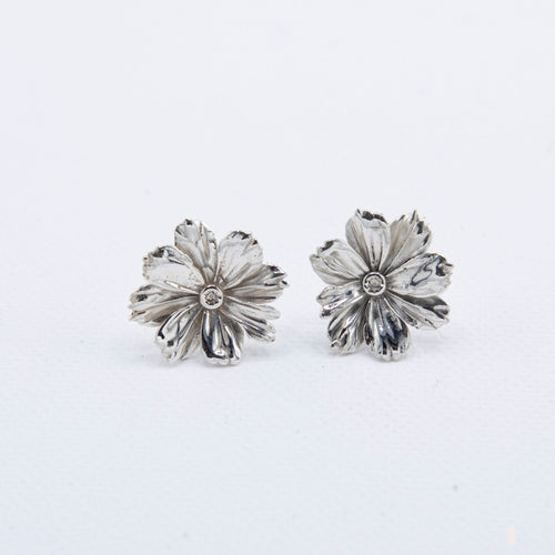 Hand-cast sterling silver Cosmos flower earrings with detailed petal texture, handmade jewellery by RHYN, made in Cape Town.