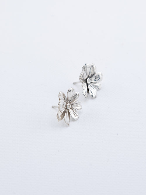 Hand-cast sterling silver Cosmos flower earrings with detailed petal texture, handmade jewellery by RHYN, made in Cape Town.